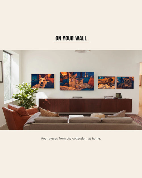 A bright living room with four pieces from The House That Filled Up on the wall: Ghost and Baby Junior on a large screen, Bruce Lee, Tupac and Mini in frames beside it
